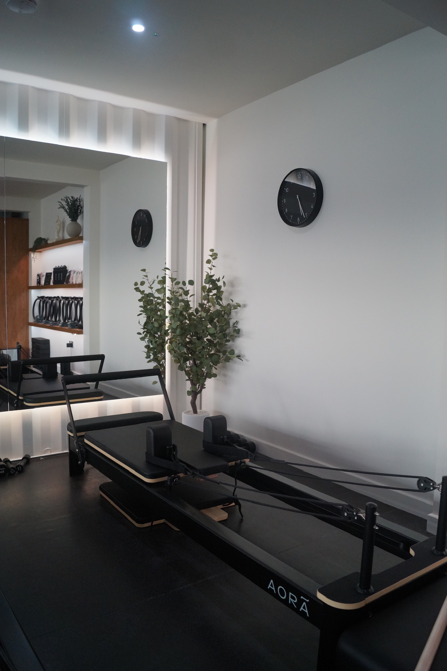 Instructor guiding student at AORA studio